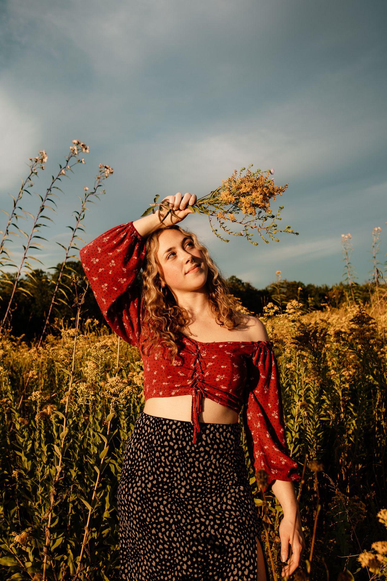 Girl holding flowers in a field 